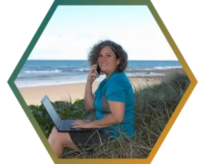 Lisa Jane Hawthorne with her laptop at the beach